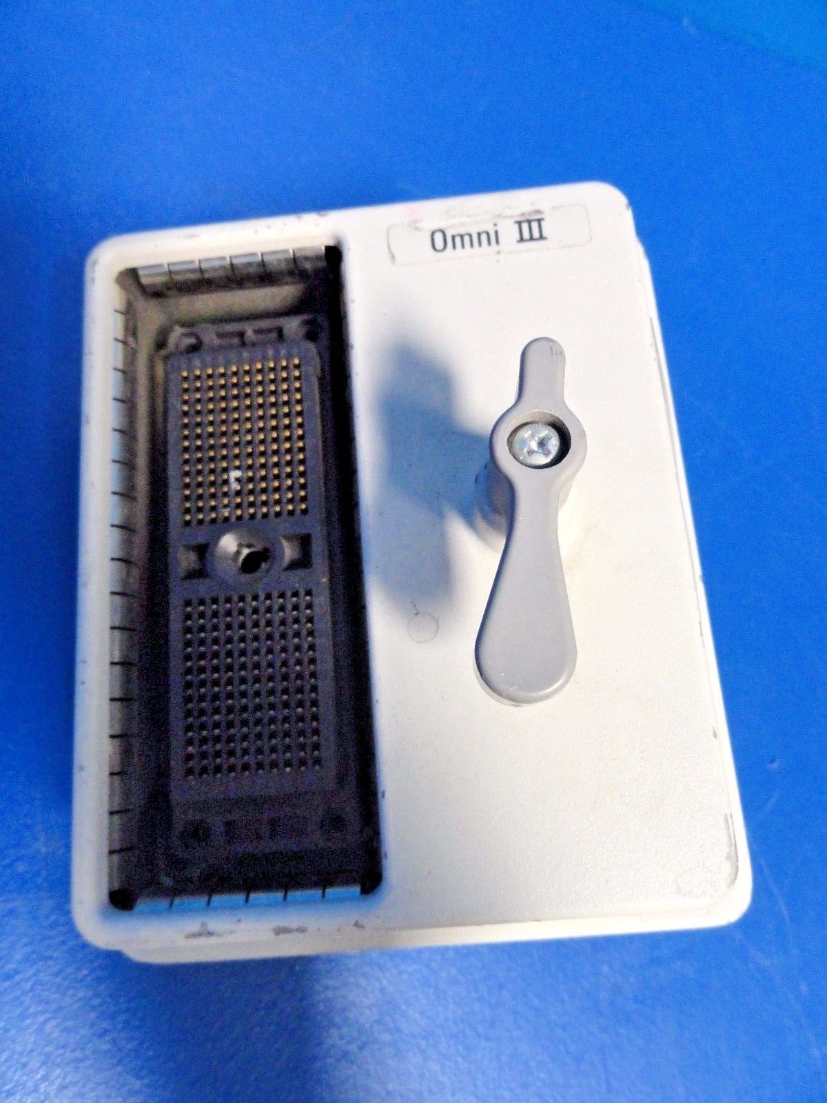 a small electronic device sitting on top of a blue table