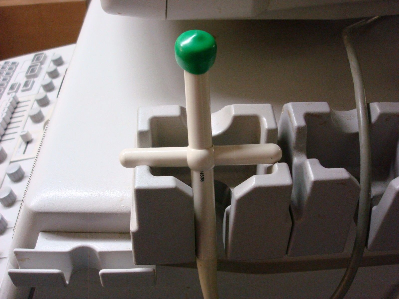 a close up of a computer keyboard with a green button