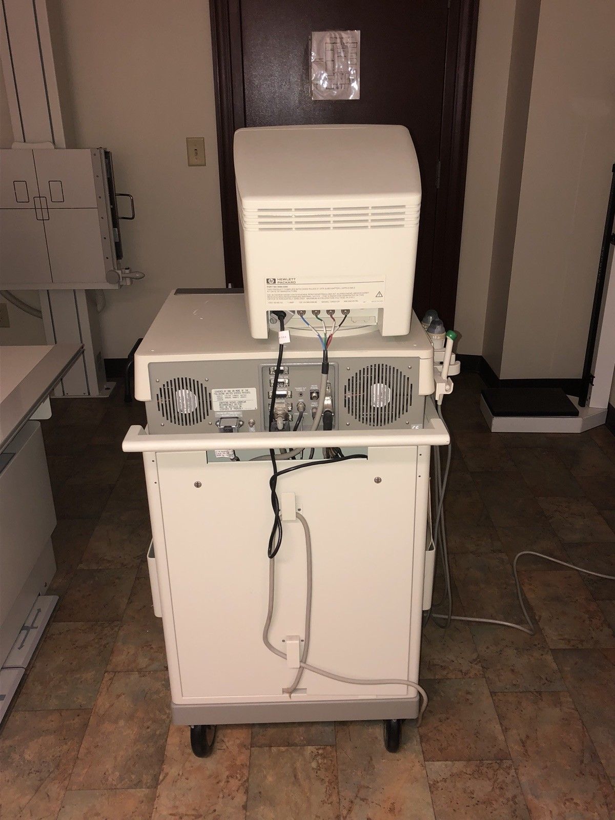 a white machine sitting on top of a tiled floor